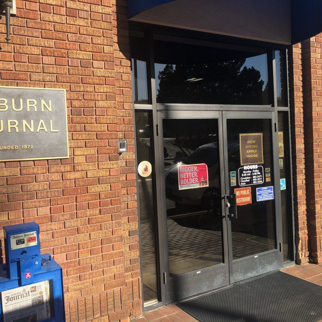 A brick building with a sign that says burn journal