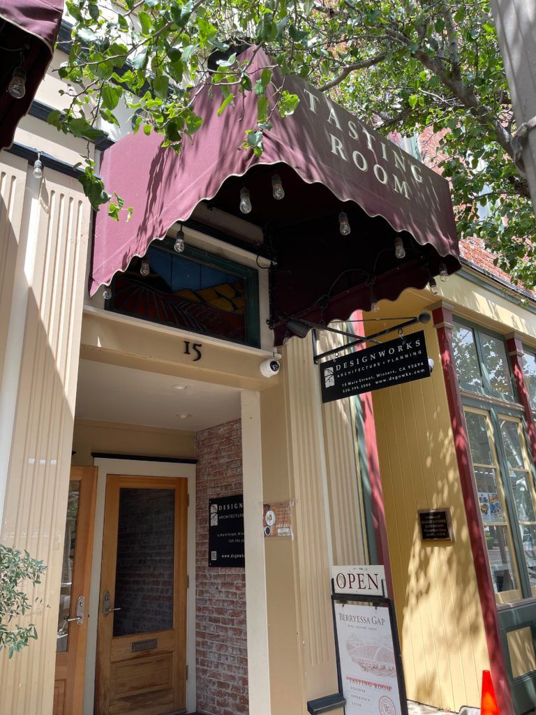 A building with a purple awning over the entrance.