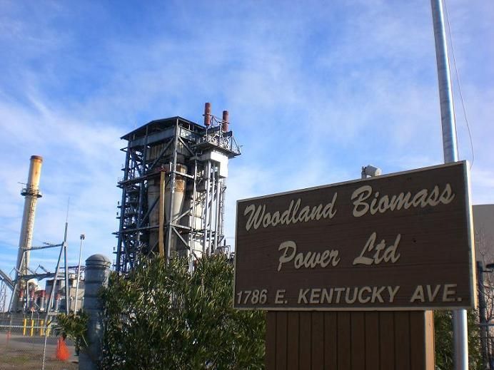 A woodland biomass power ltd sign in front of a factory