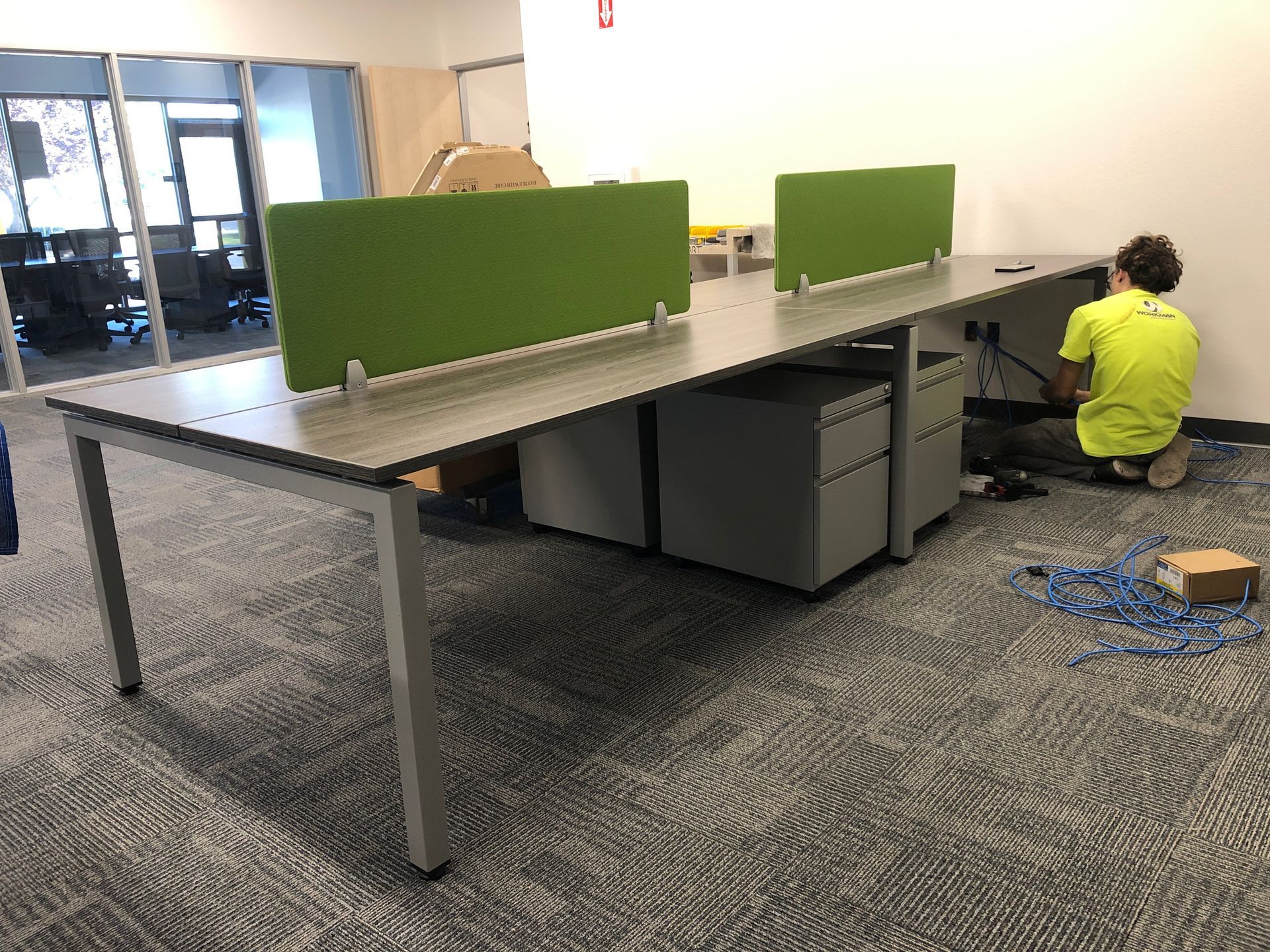 A man is working on a desk in an office.