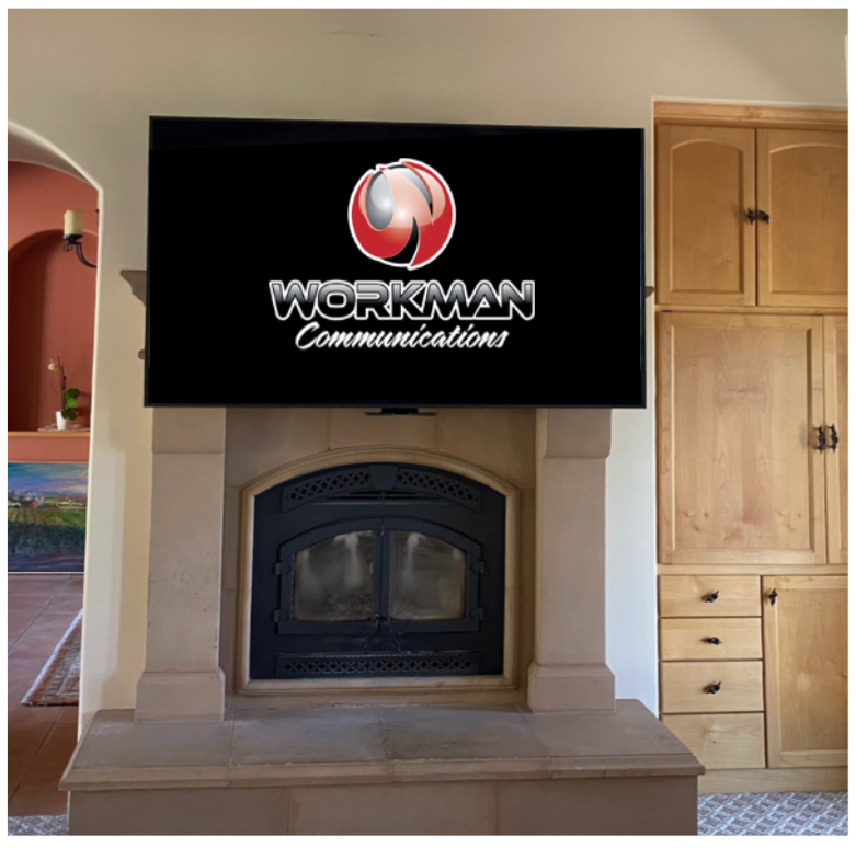 A workman communications television is mounted above a fireplace