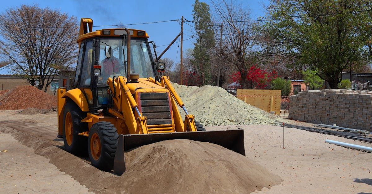 A yellow bulldozer is moving a pile of dirt on a construction site.