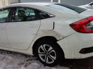 White Car With A Damaged Fender | Faribault, MN | Midwest Collision