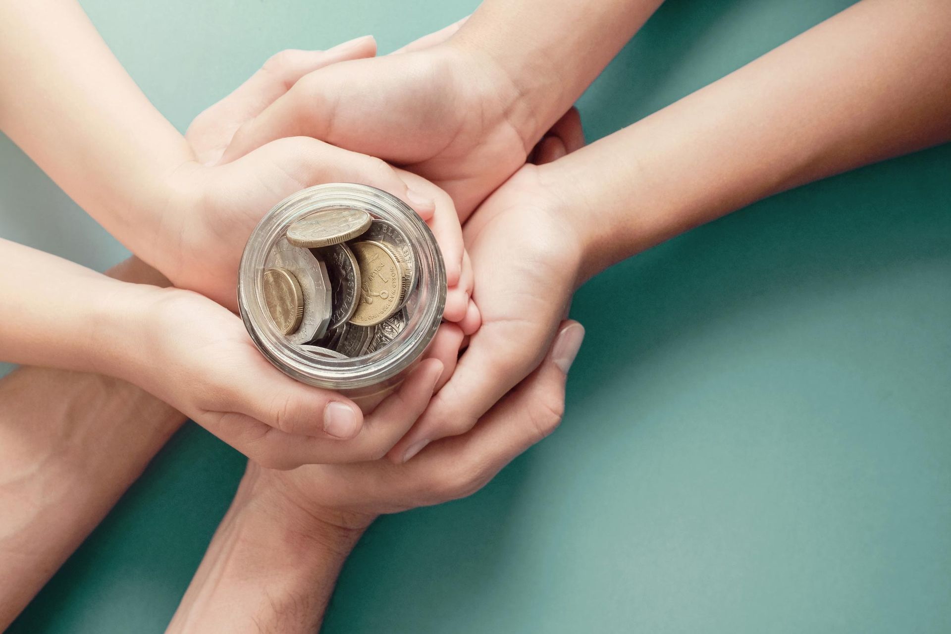 Child And Parent Hands Holding Money Jar — Corcoran, MN — St John's Evangelical Lutheran