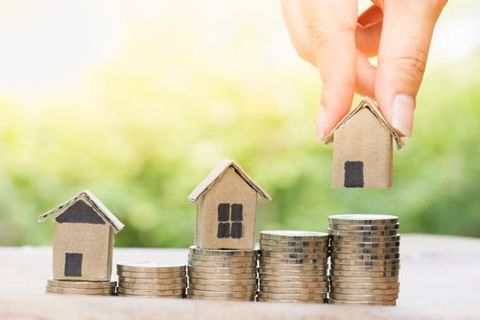 house standing on stack of coins