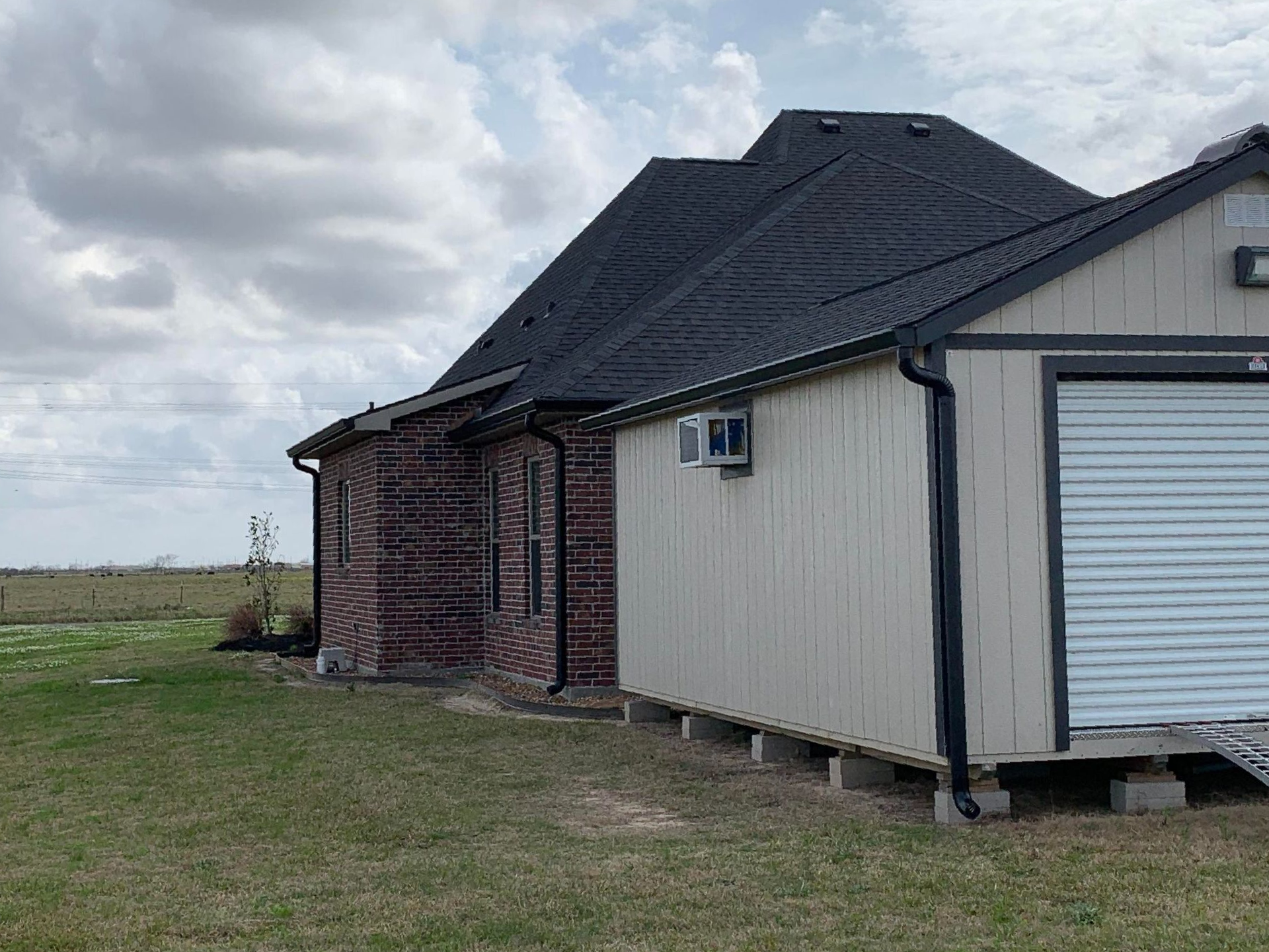 A brick house with a garage next to it.
