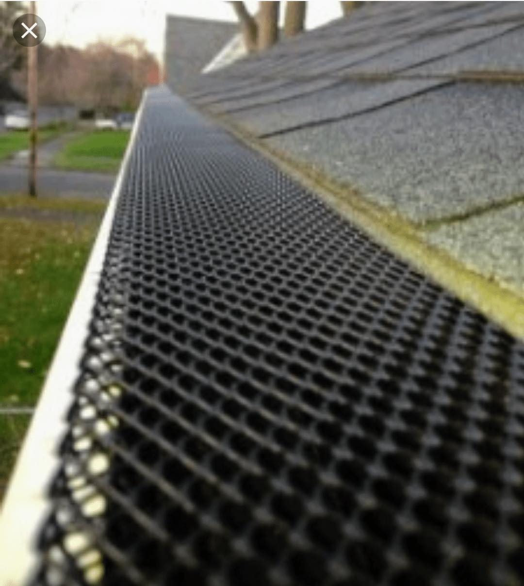 A close up of a gutter with a mesh on it