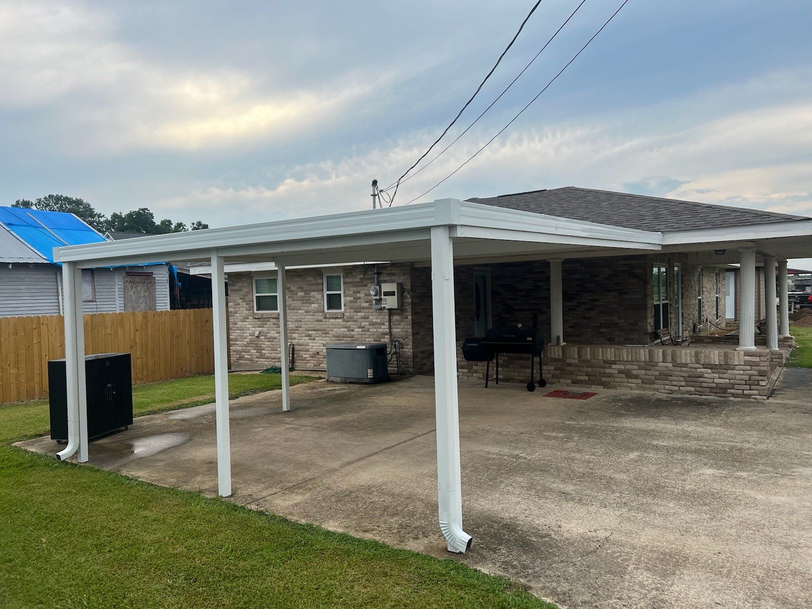 A house with a covered patio in front of it.