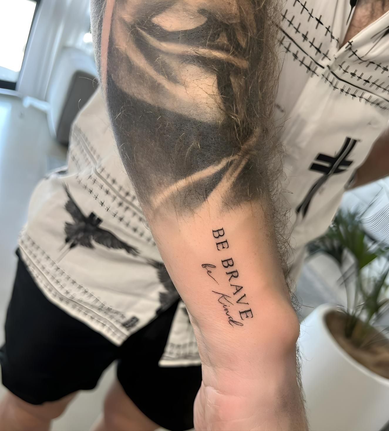 A Man Has a Tattoo on His Arm That Says Be Brave  — Tattoo Inc Studio In Broadbeach, QLD