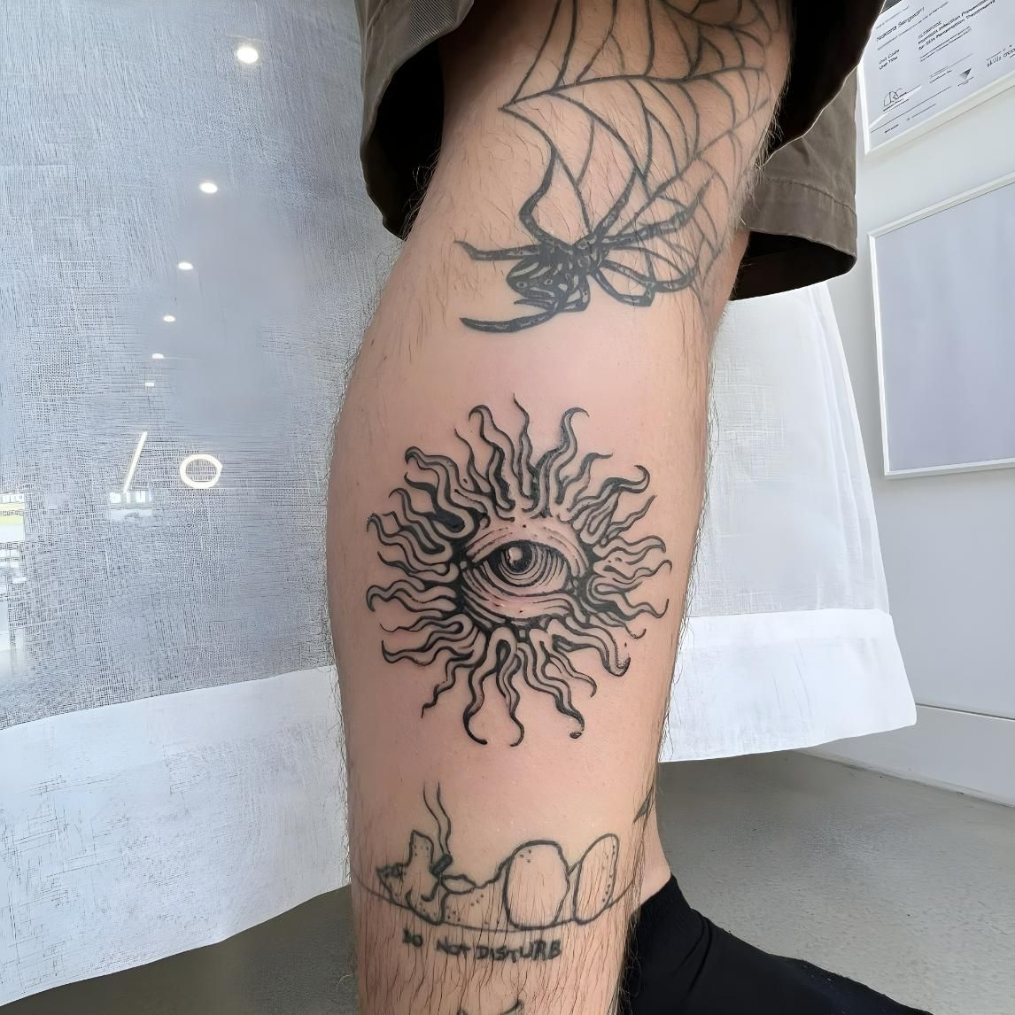 A Person Has a Tattoo of a Sun With an Eye on It — Tattoo Inc Studio in Broadbeach, QLD