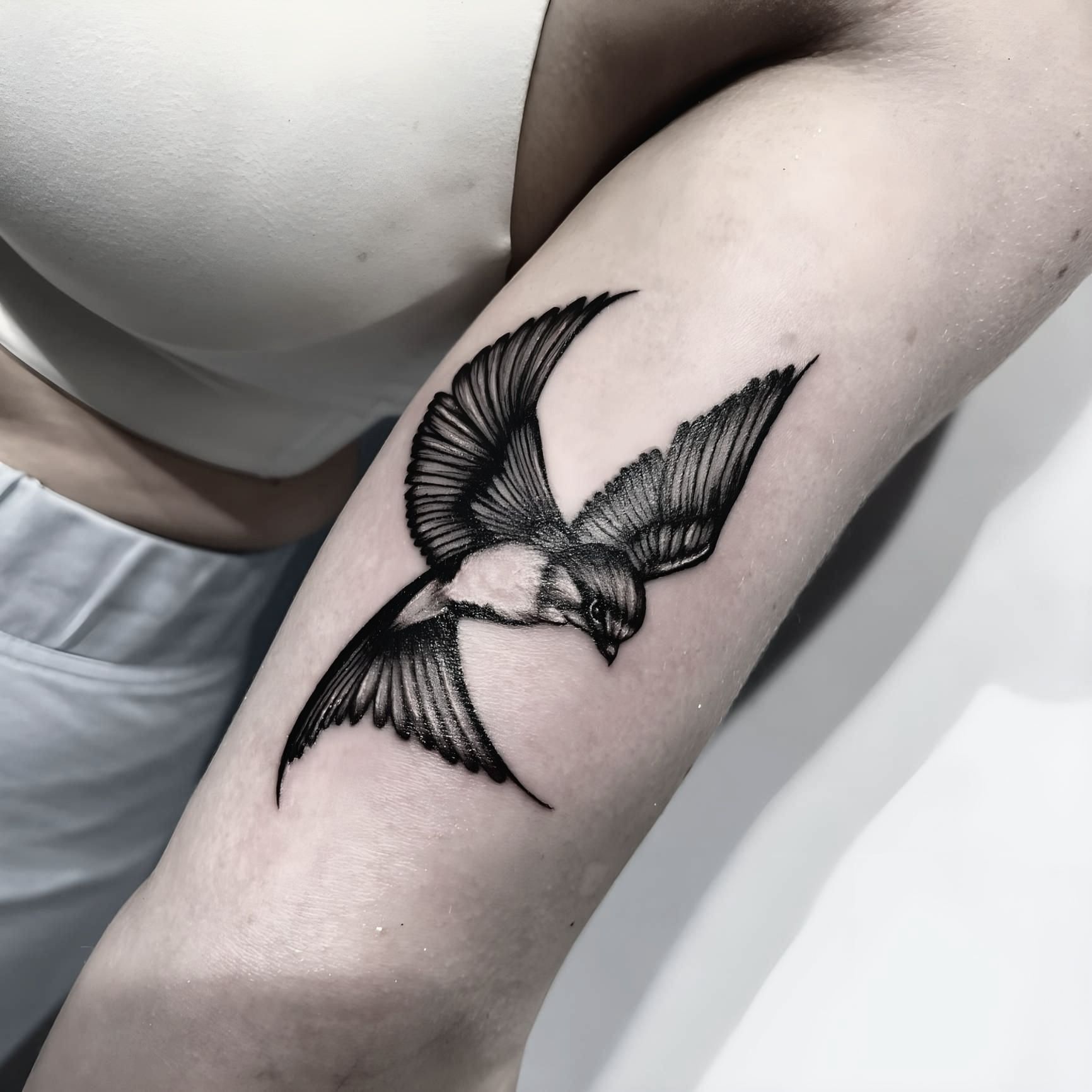 A Woman Has a Tattoo of a Bird on Her Arm — Tattoo Inc Studio In Broadbeach, QLD