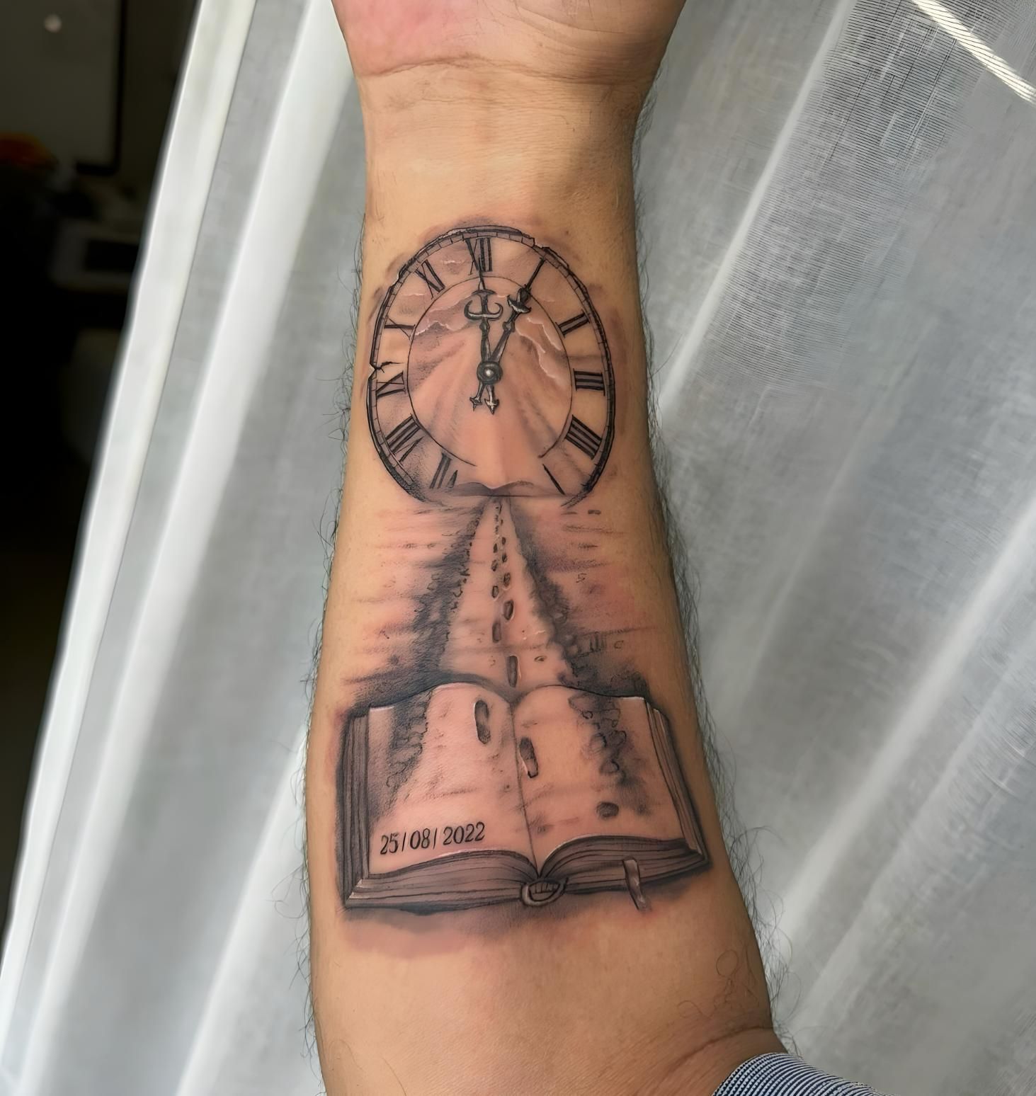 A Man Has a Tattoo of a Clock and an Open Book on His Forearm — Tattoo Inc Studio In Broadbeach, QLD