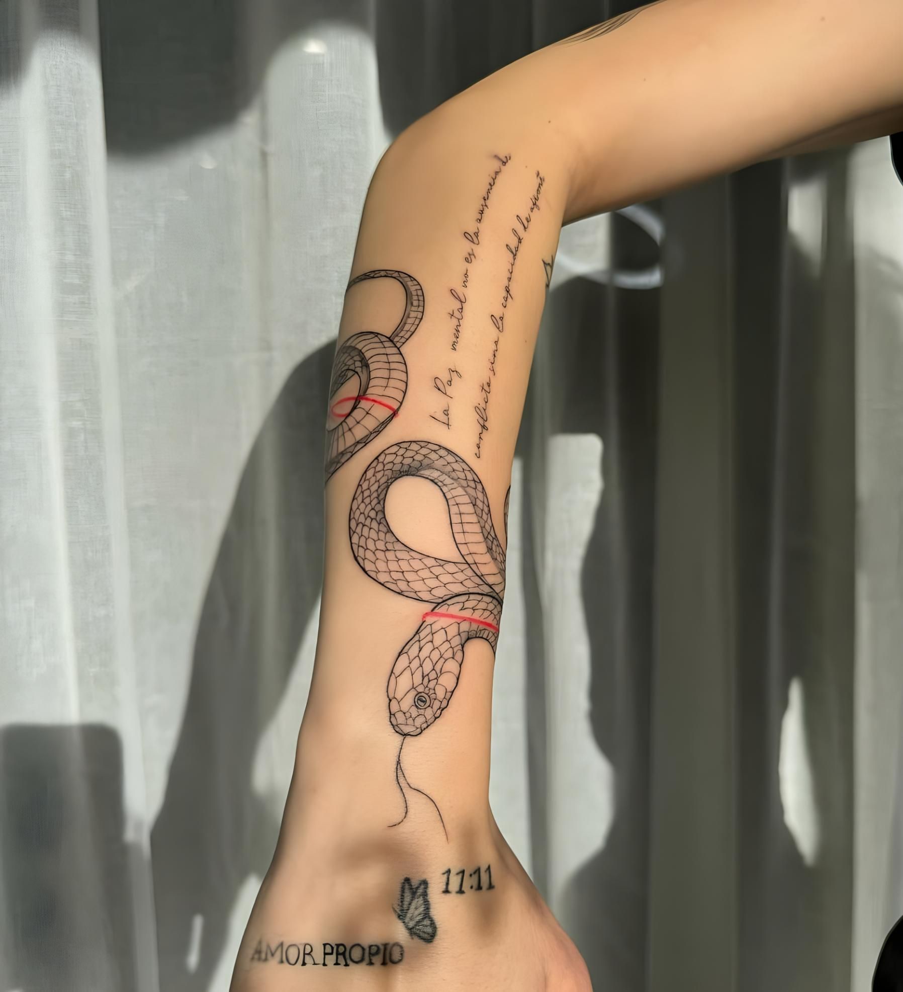 A Woman Has a Tattoo of a Snake on Her Arm — Tattoo Inc Studio in Robina, QLD