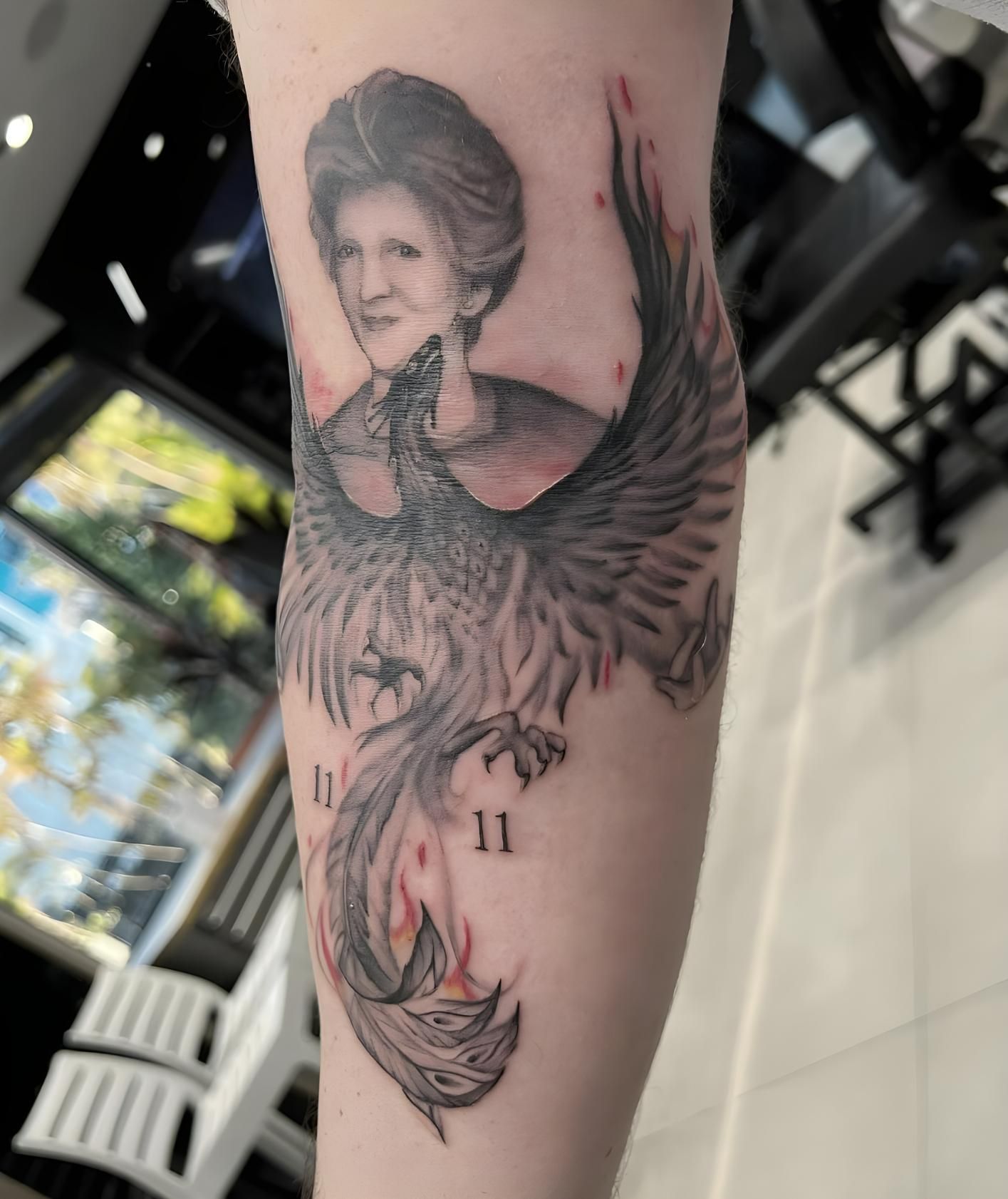 A Woman Has a Tattoo of a Phoenix on Her Arm — Tattoo Inc Studio in Robina, QLD