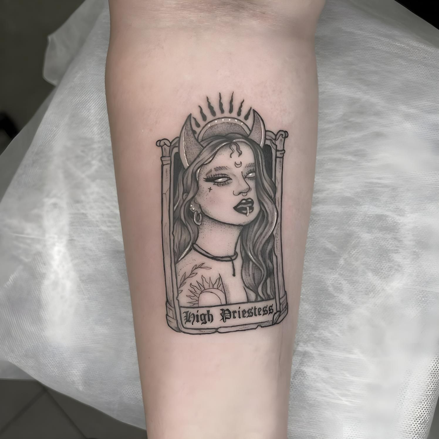 Tattoo of a woman in a frame, labeled 