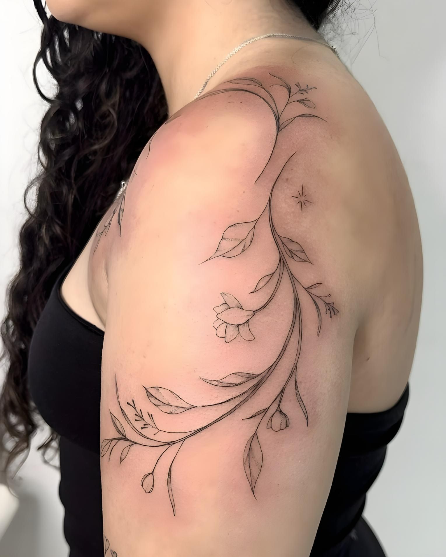 A Woman Has a Tattoo of Flowers on Her Shoulder — Tattoo Inc Studio in Surfers Paradise, QLD