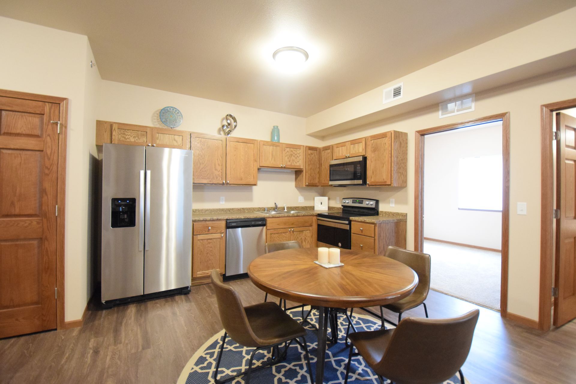 a kitchen with stainless steel appliances and wood cabinets