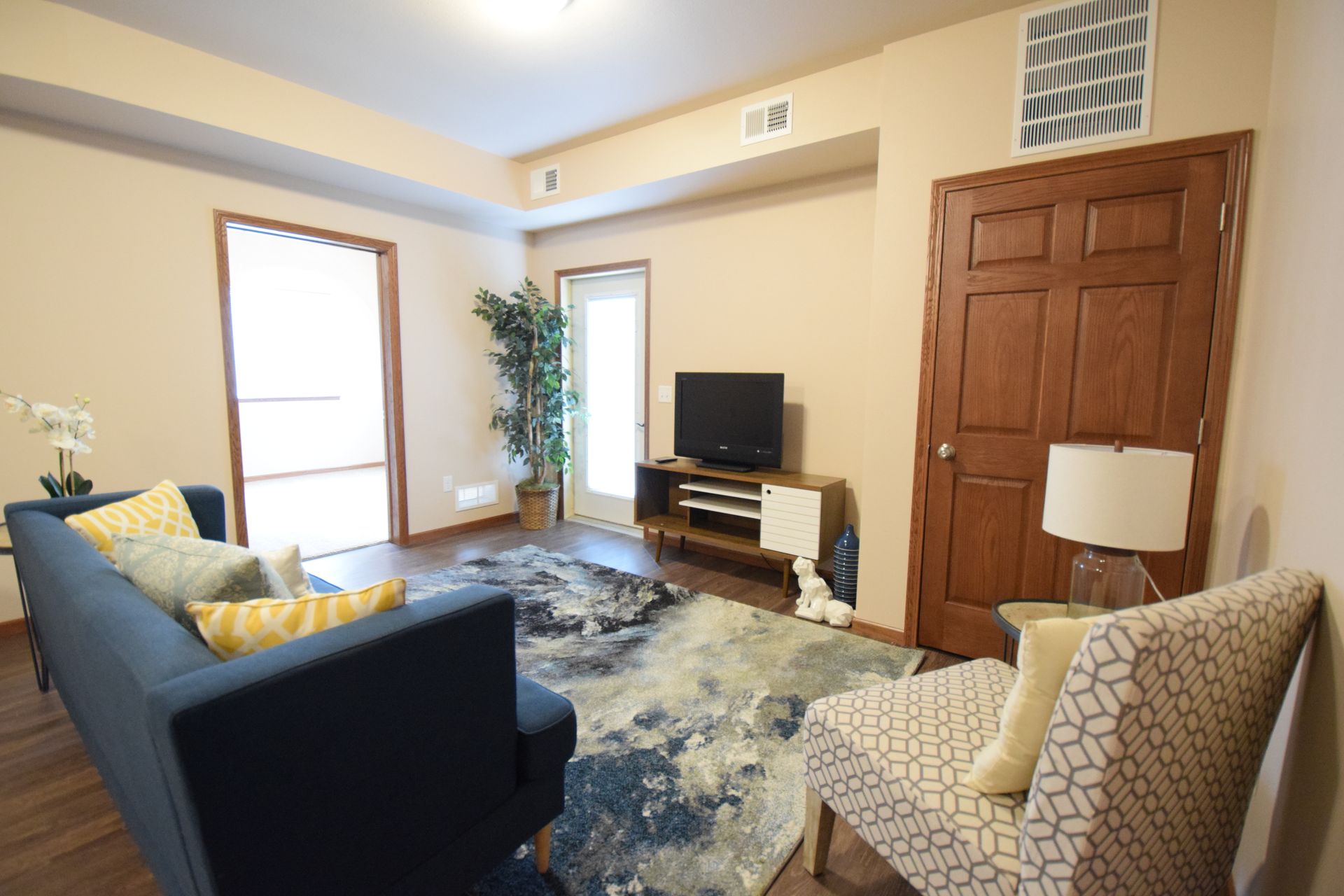 a living room with a couch a chair and a television