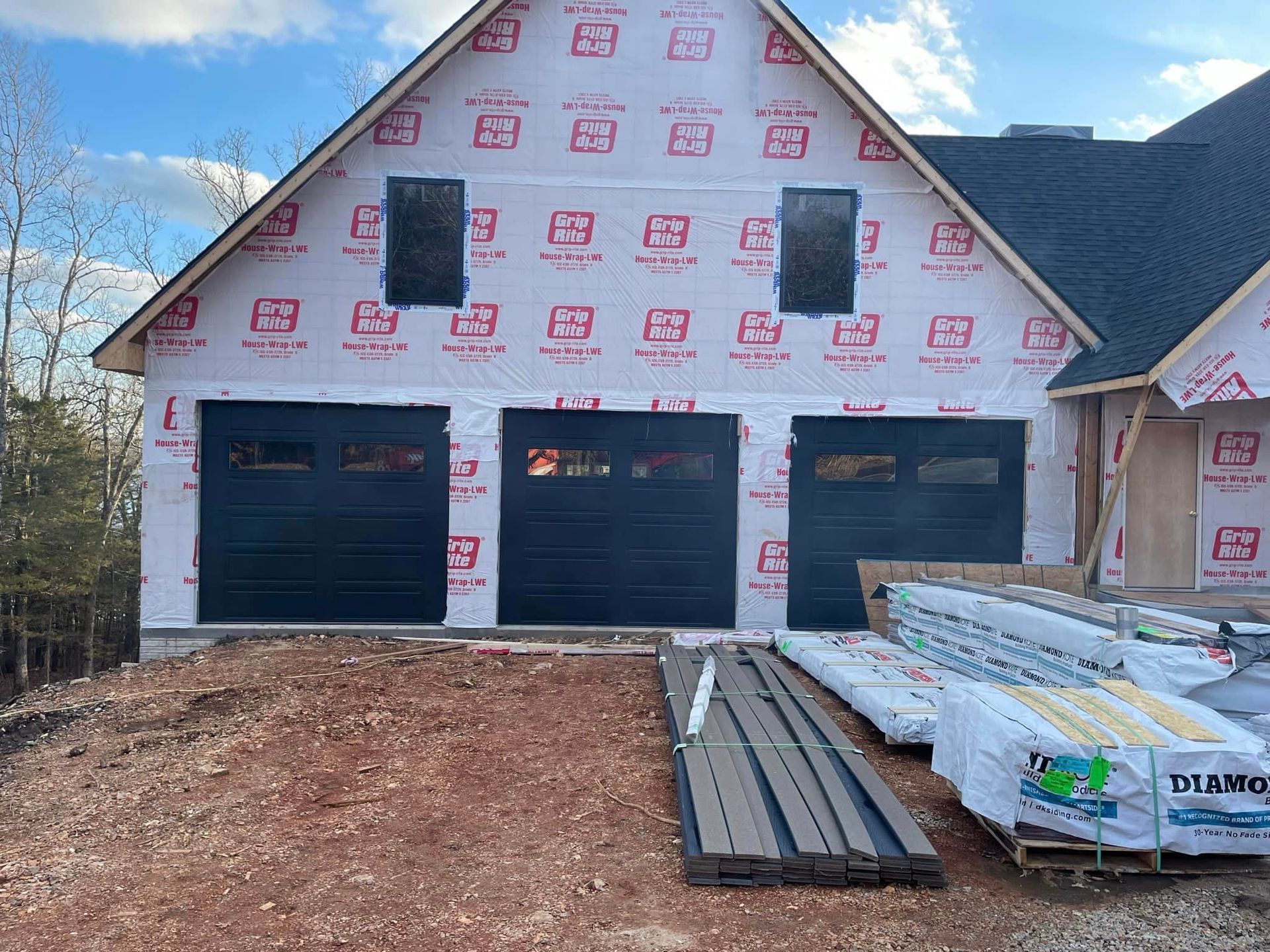 A house is being built with a lot of insulation on the side of it.