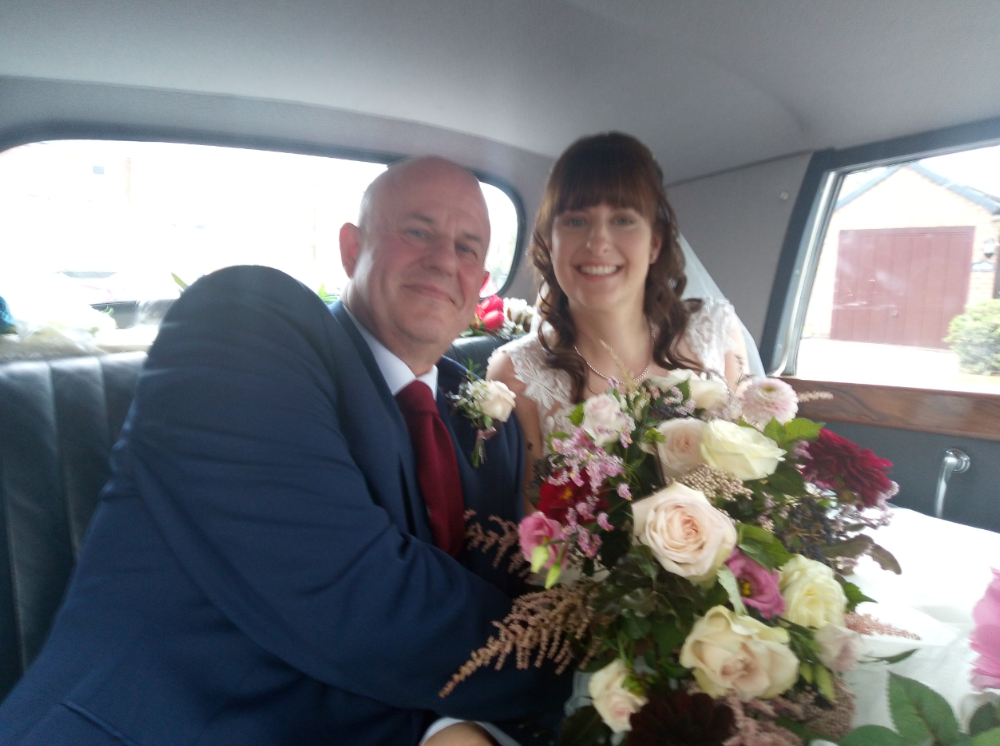 Groom and bride inside the wedding car