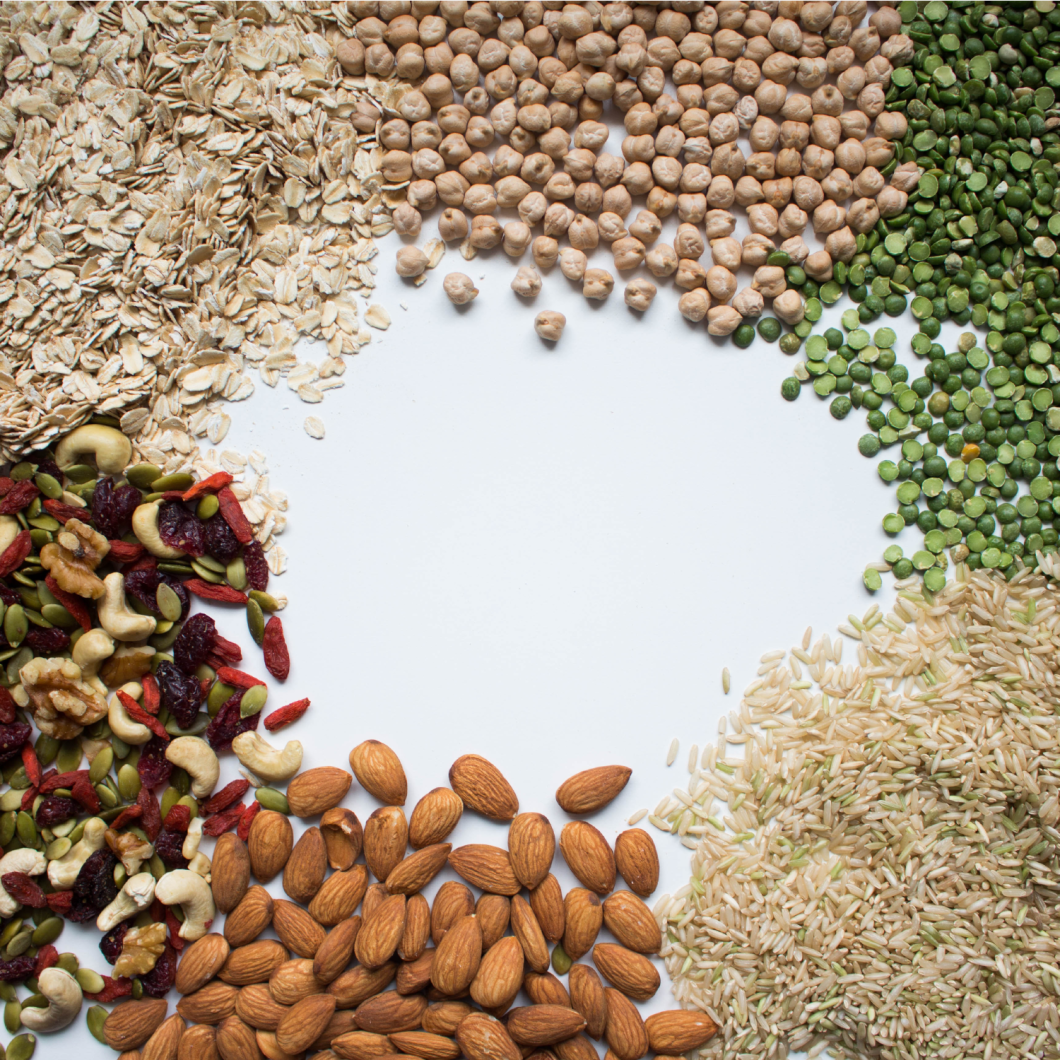 Various nuts and legumes are spread across a table