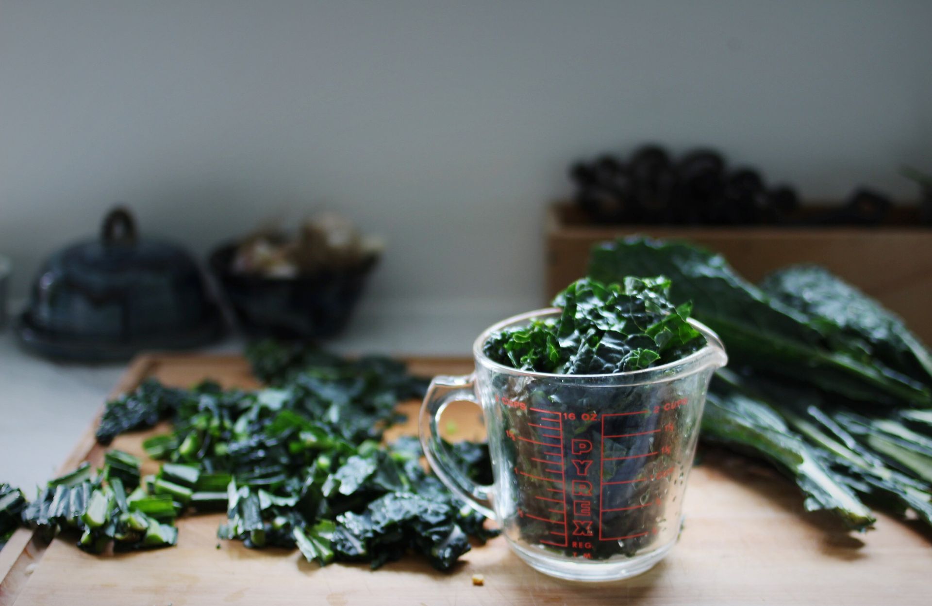 kale chopped on cutting board and in a glass measuring cup