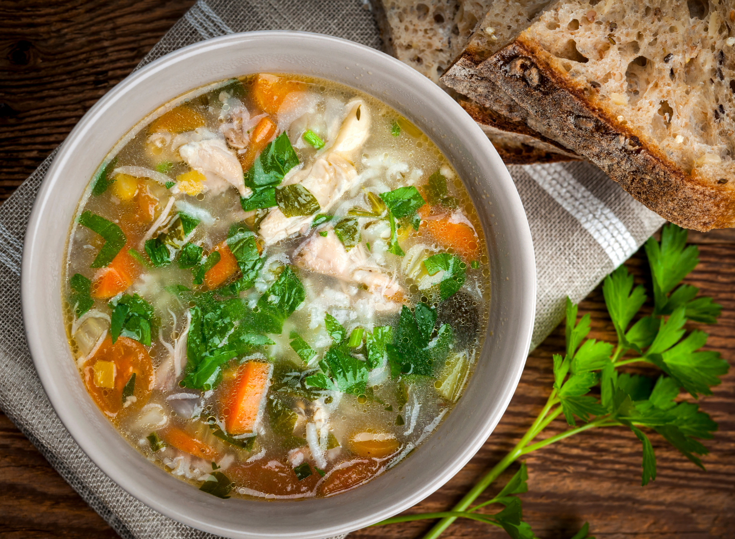 bowl of soup next to crockpot with soup in it