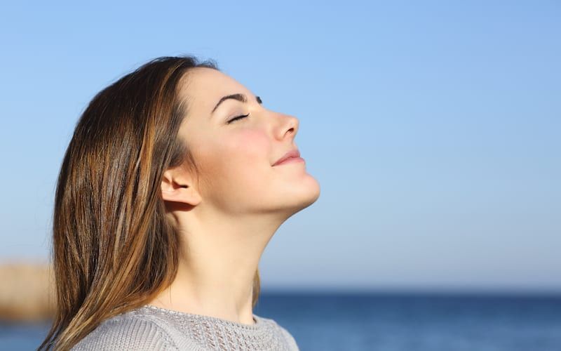 woman smiling facing the sky