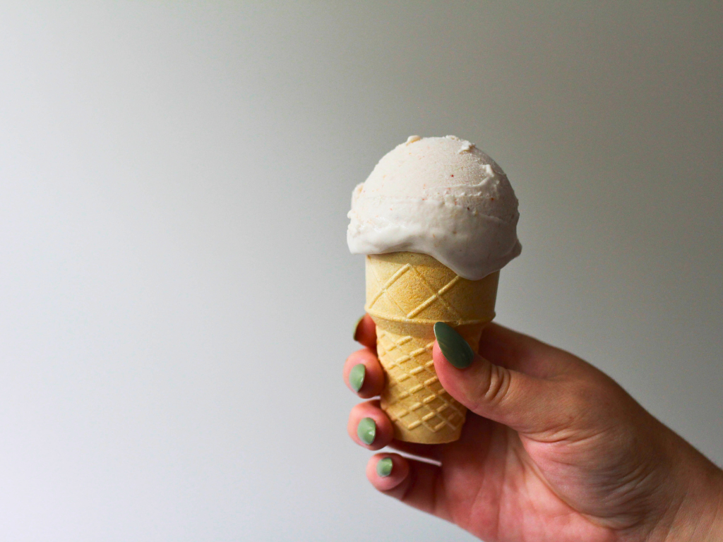 hand holding vanilla ice cream cone