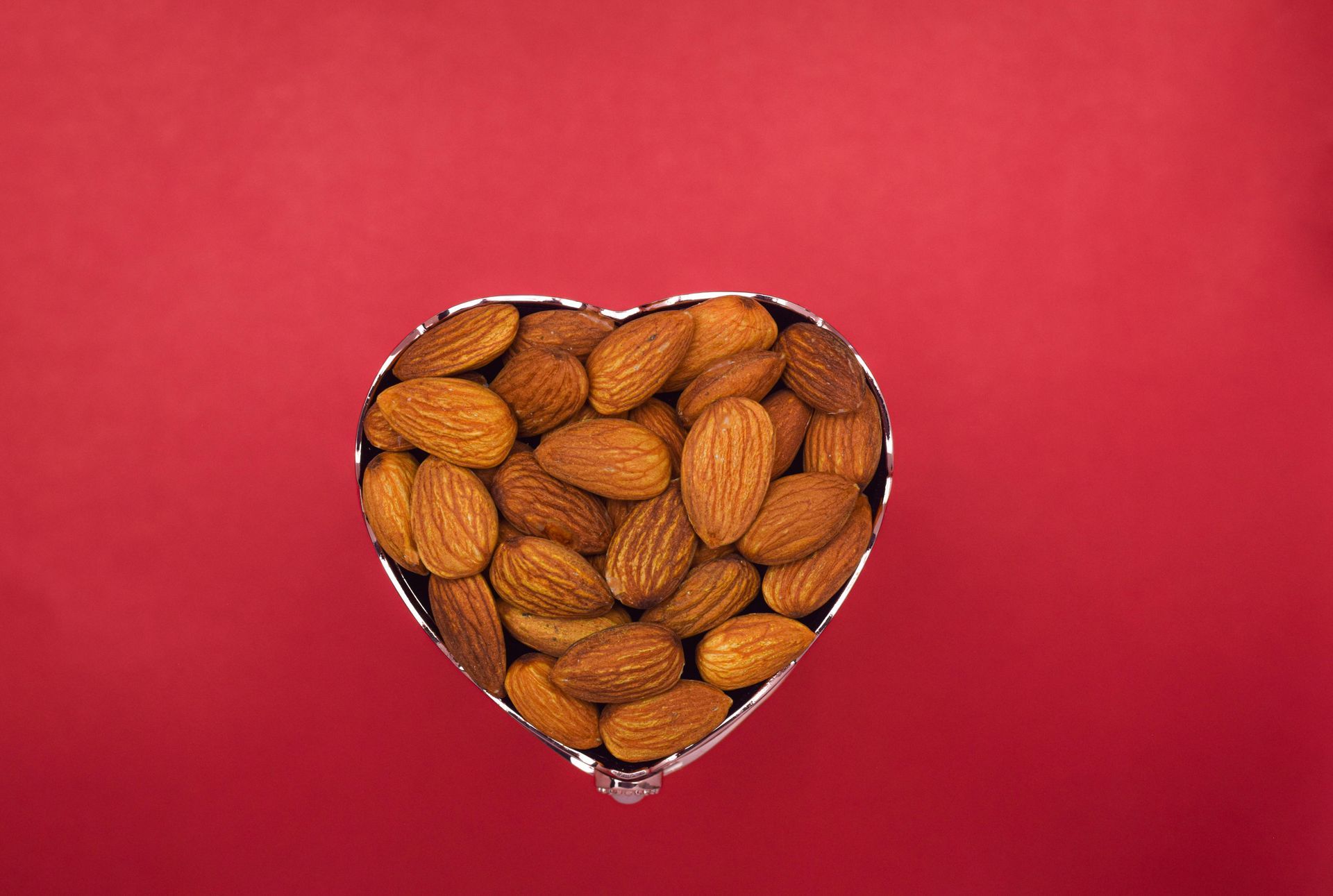 Heart shaped bowl filled with almonds