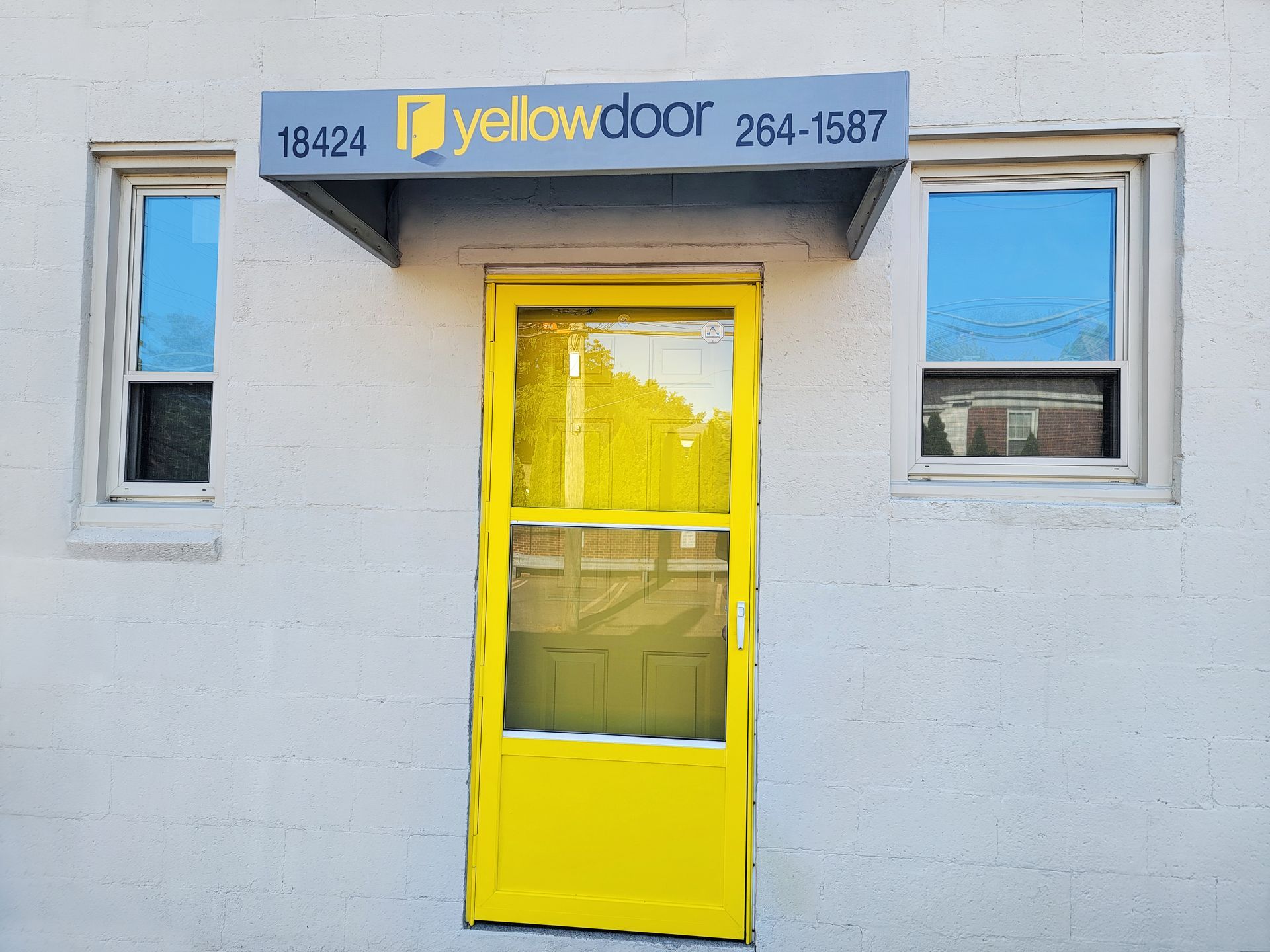 A yellow door with a sign that says yellow door