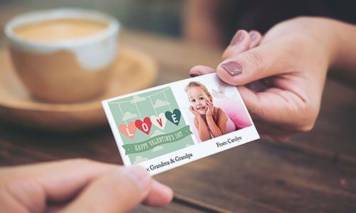 one handing handing over a mini card to another hand