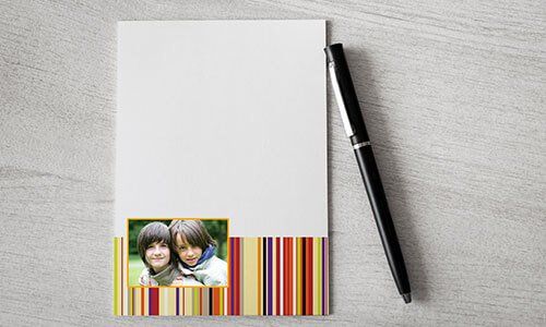 a notepad next to a pen on a table