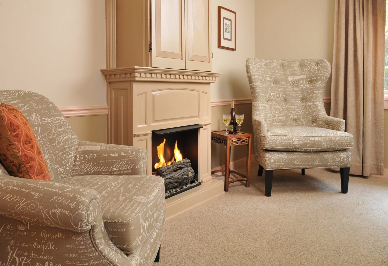 A living room with two chairs and a fireplace