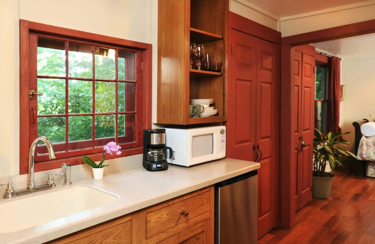 A kitchen with a sink a microwave and a coffee maker