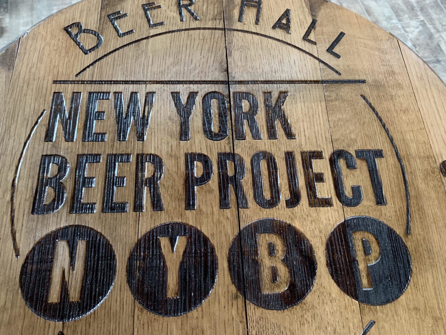 A wooden sign for the new york beer project