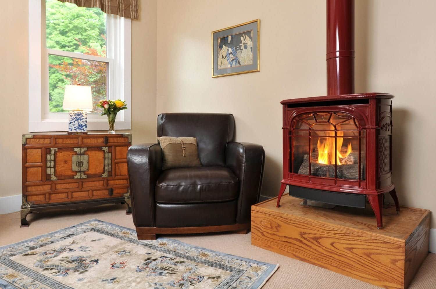 A living room with a chair and a red stove