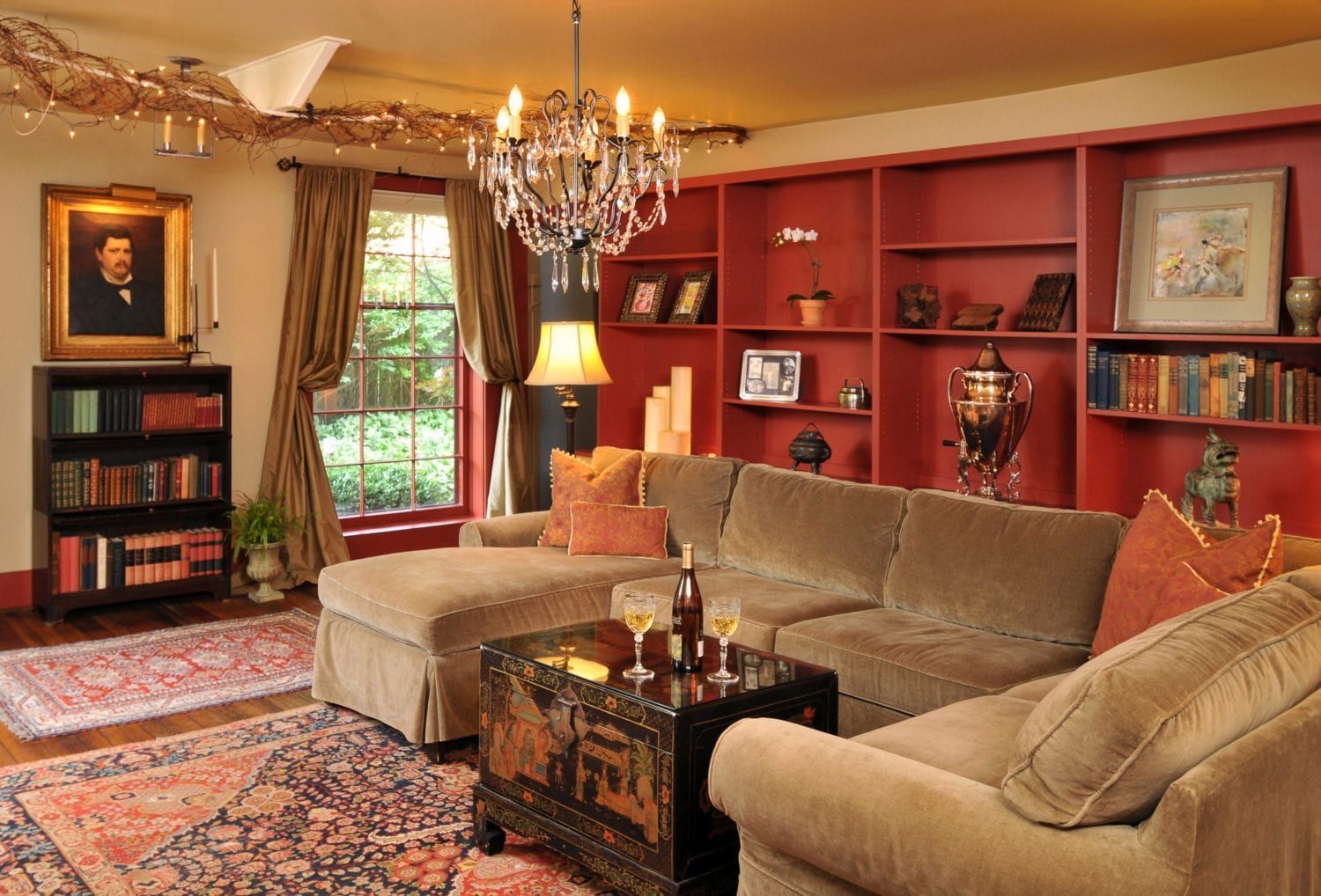 A living room with a sectional couch and a chandelier