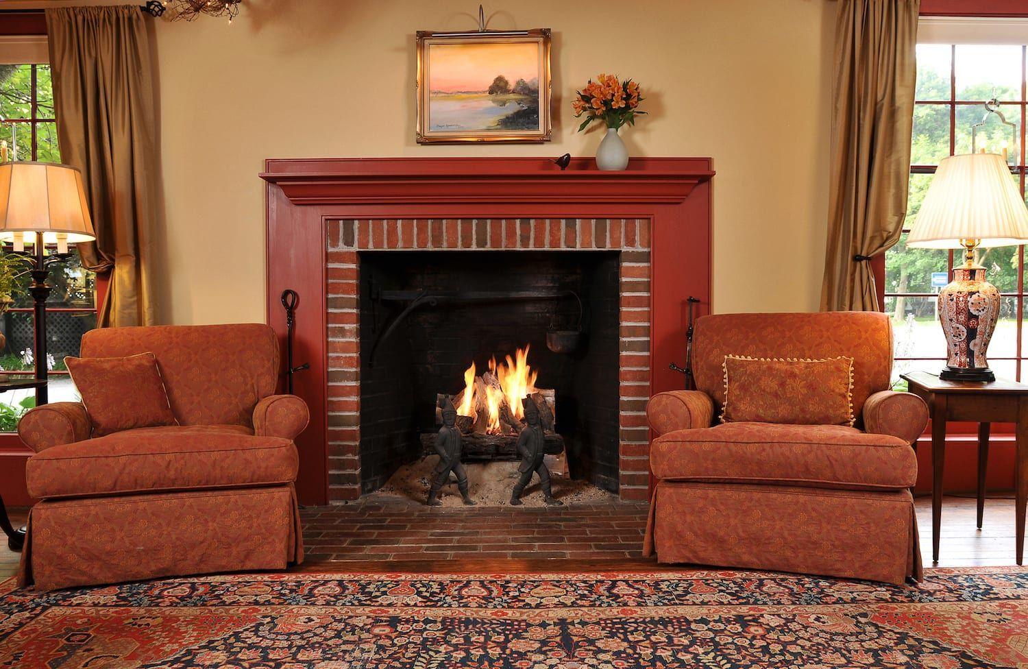 A living room with two chairs and a fireplace