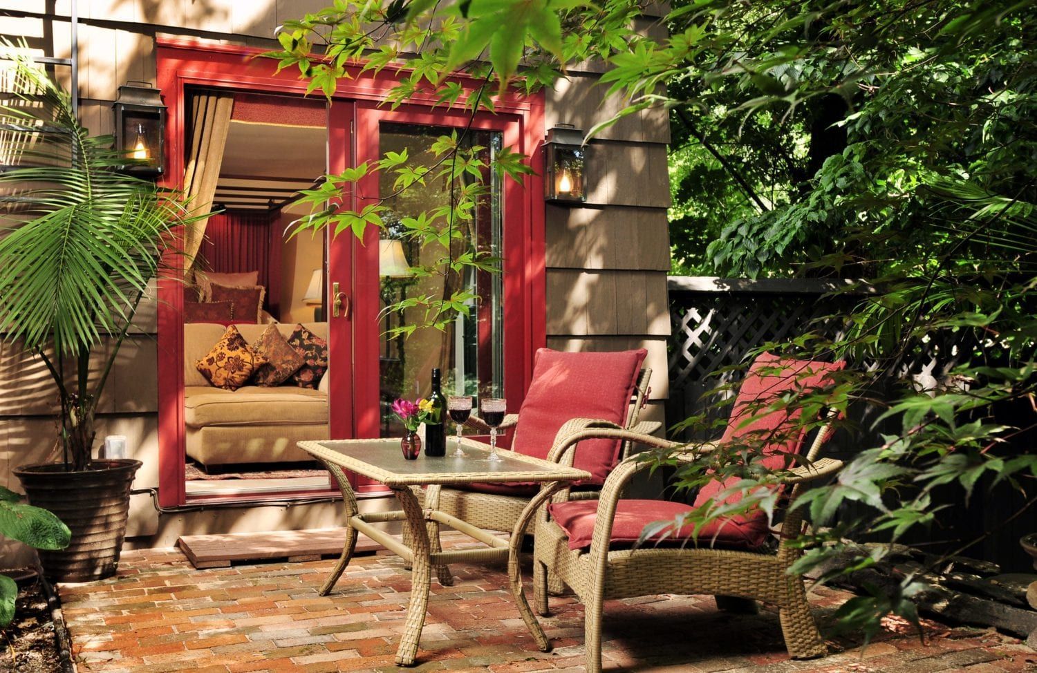 A patio with a table and chairs in front of a house