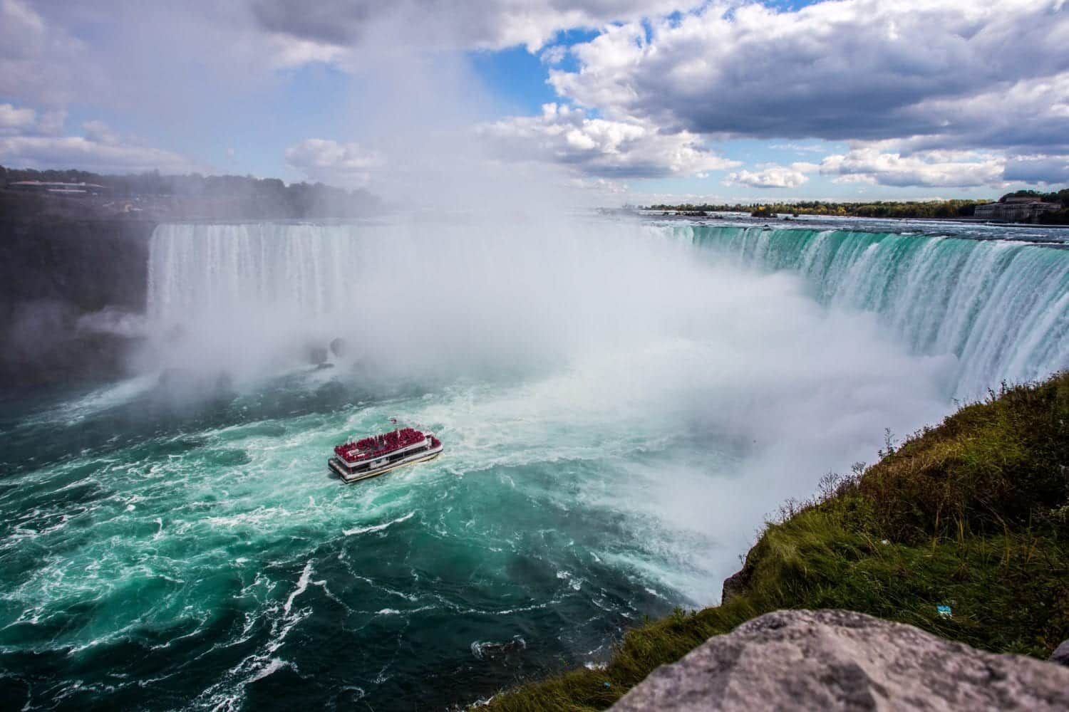 A boat is going down a waterfall in niagara falls.