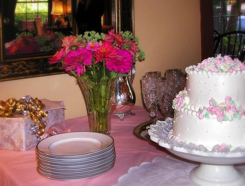 A table with plates and a cake on it