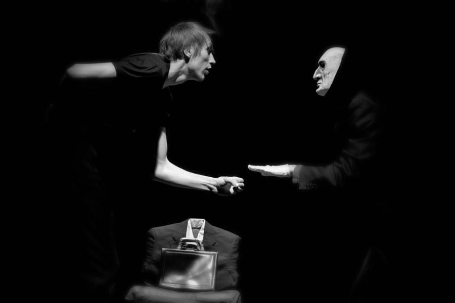 A man and a woman are shaking hands in a black and white photo.