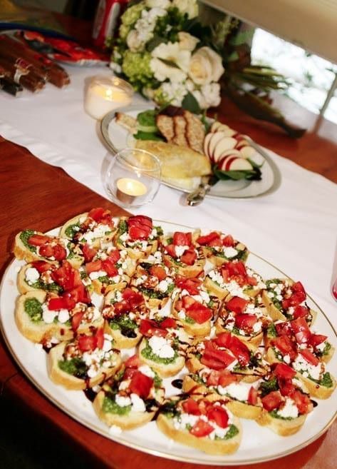 A plate of food on a table with a bouquet of flowers in the background