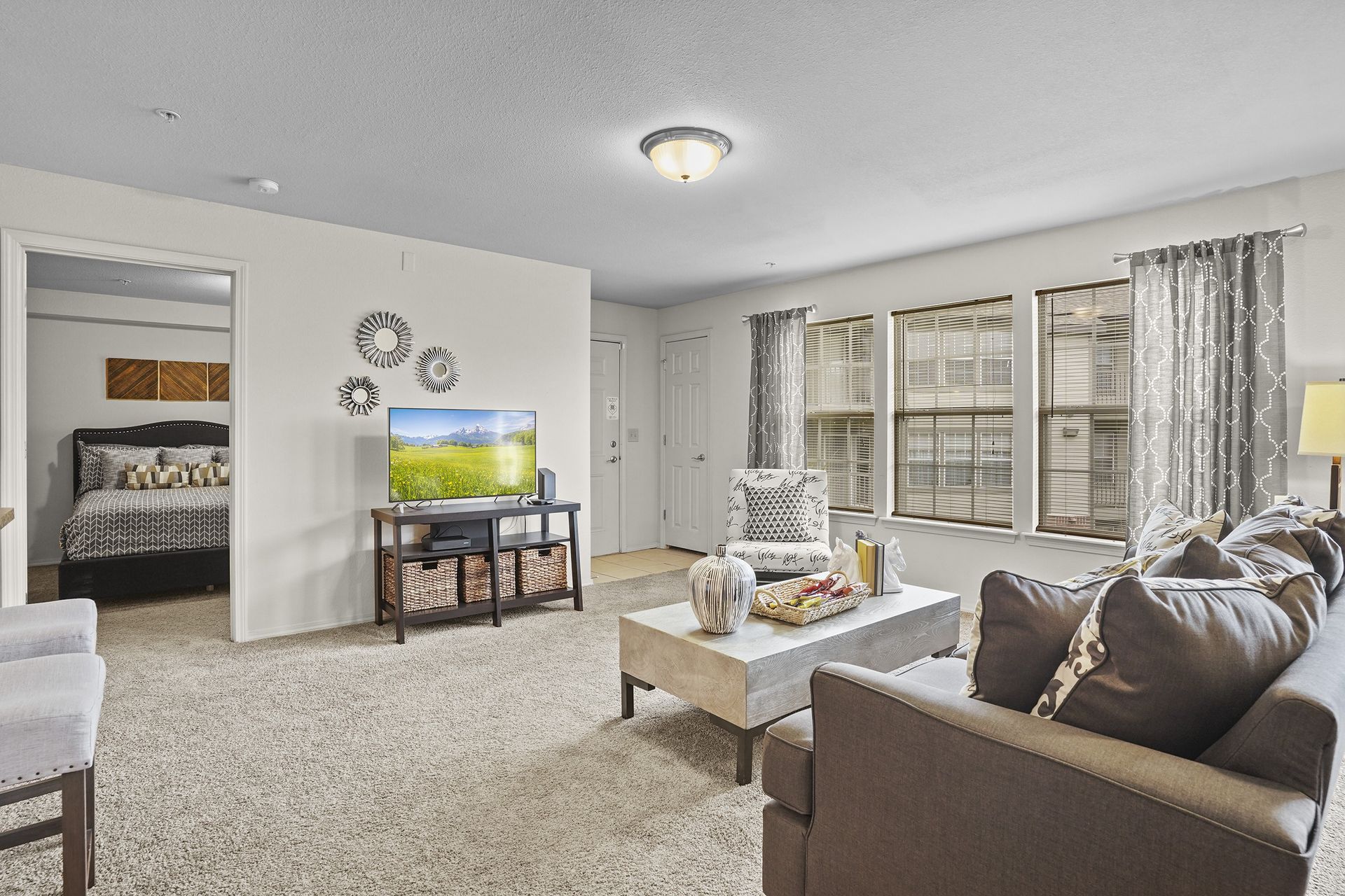 A living room with a brown couch and a television.