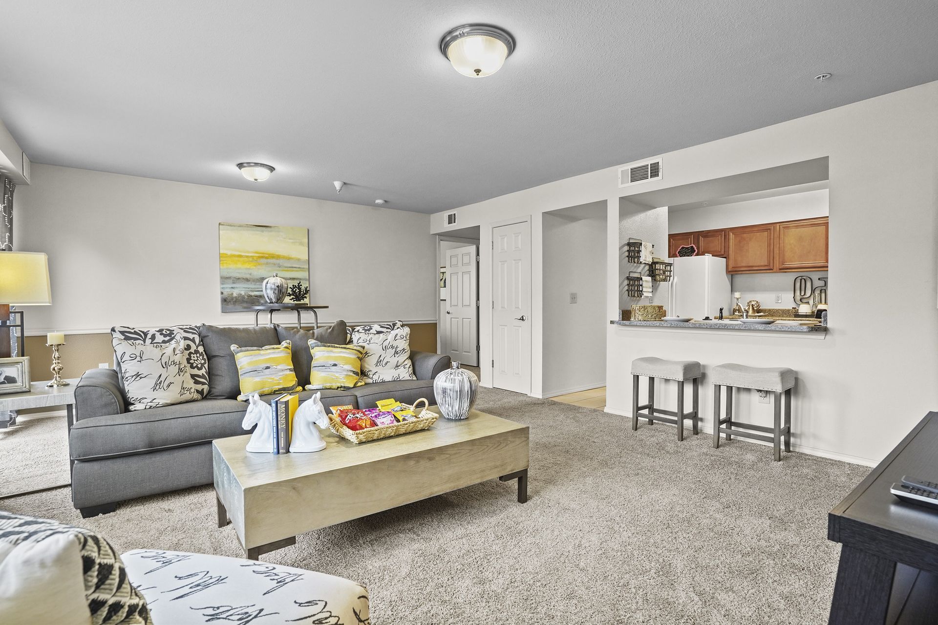 A living room with a grey couch and a coffee table.