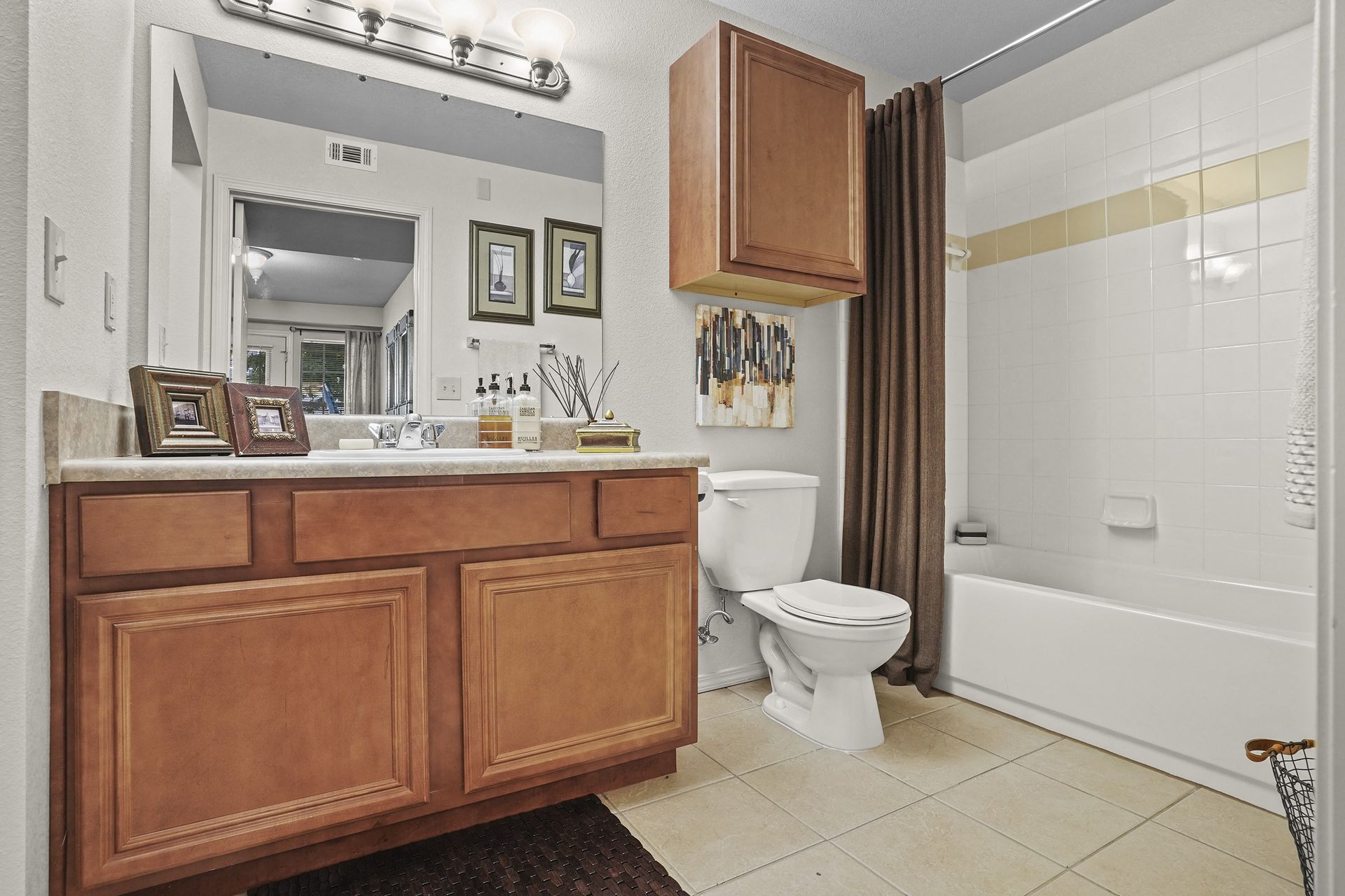 A bathroom with a white toilet and a white bathtub.
