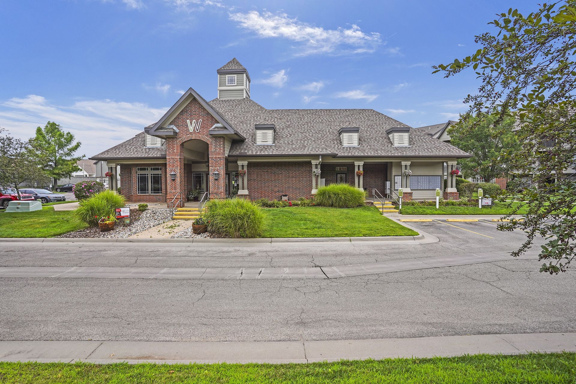A church with a steeple and a cross on the front.