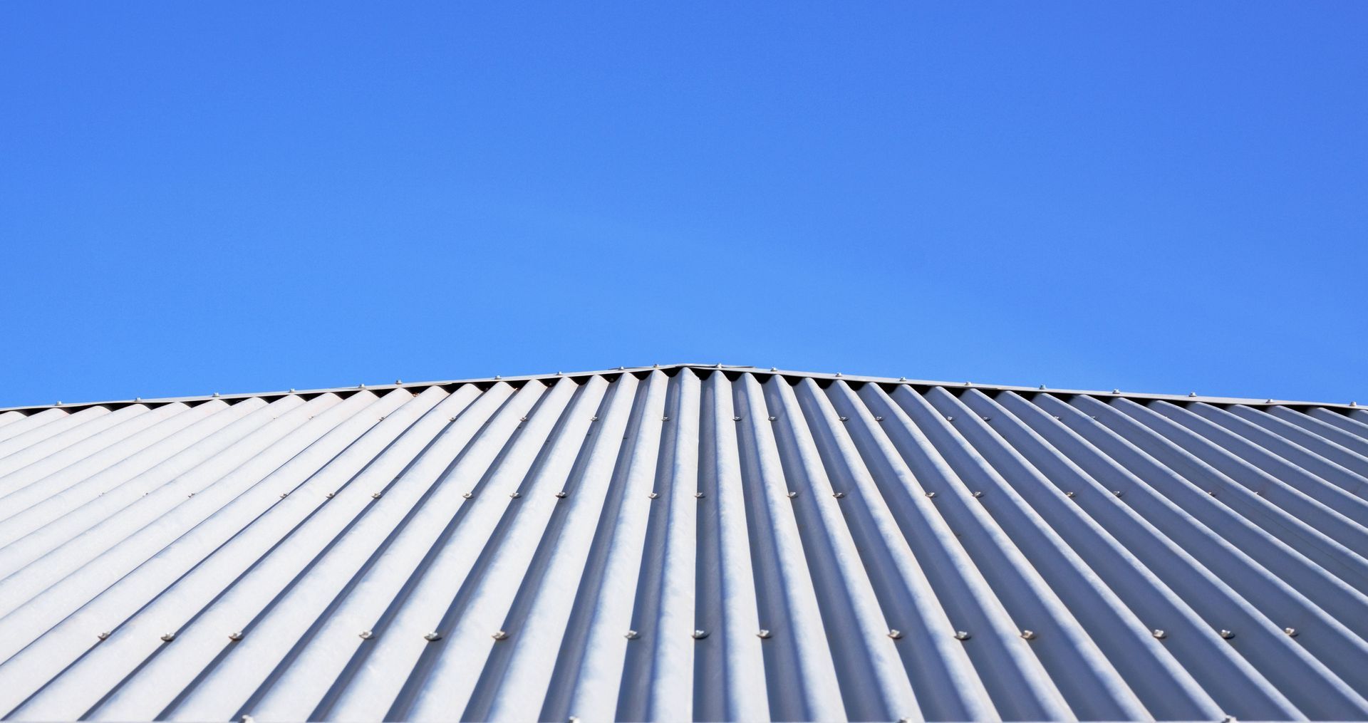 A white roof with a blue sky in the background