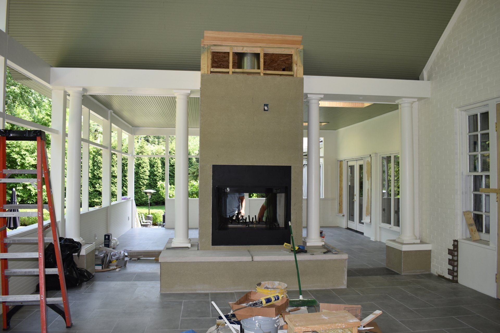 A large room with a fireplace and a ladder